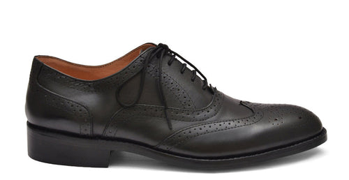 Black leather dress shoe on a white background